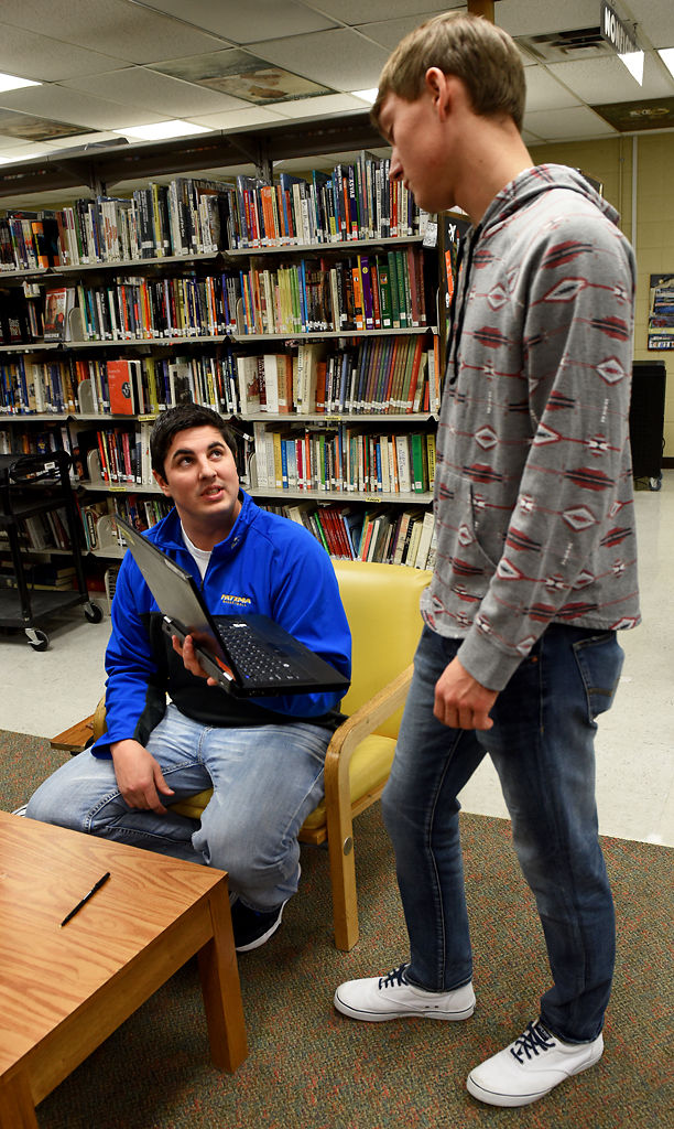 Matt Baker hands Jacob Crede back his laptop